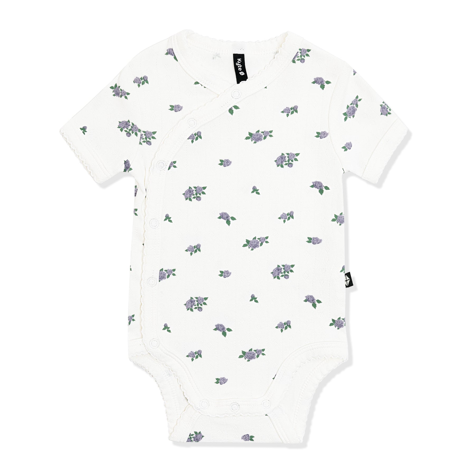Pointelle Kimono Bodysuit in Spray Rose with the picot trim shown on the white surface