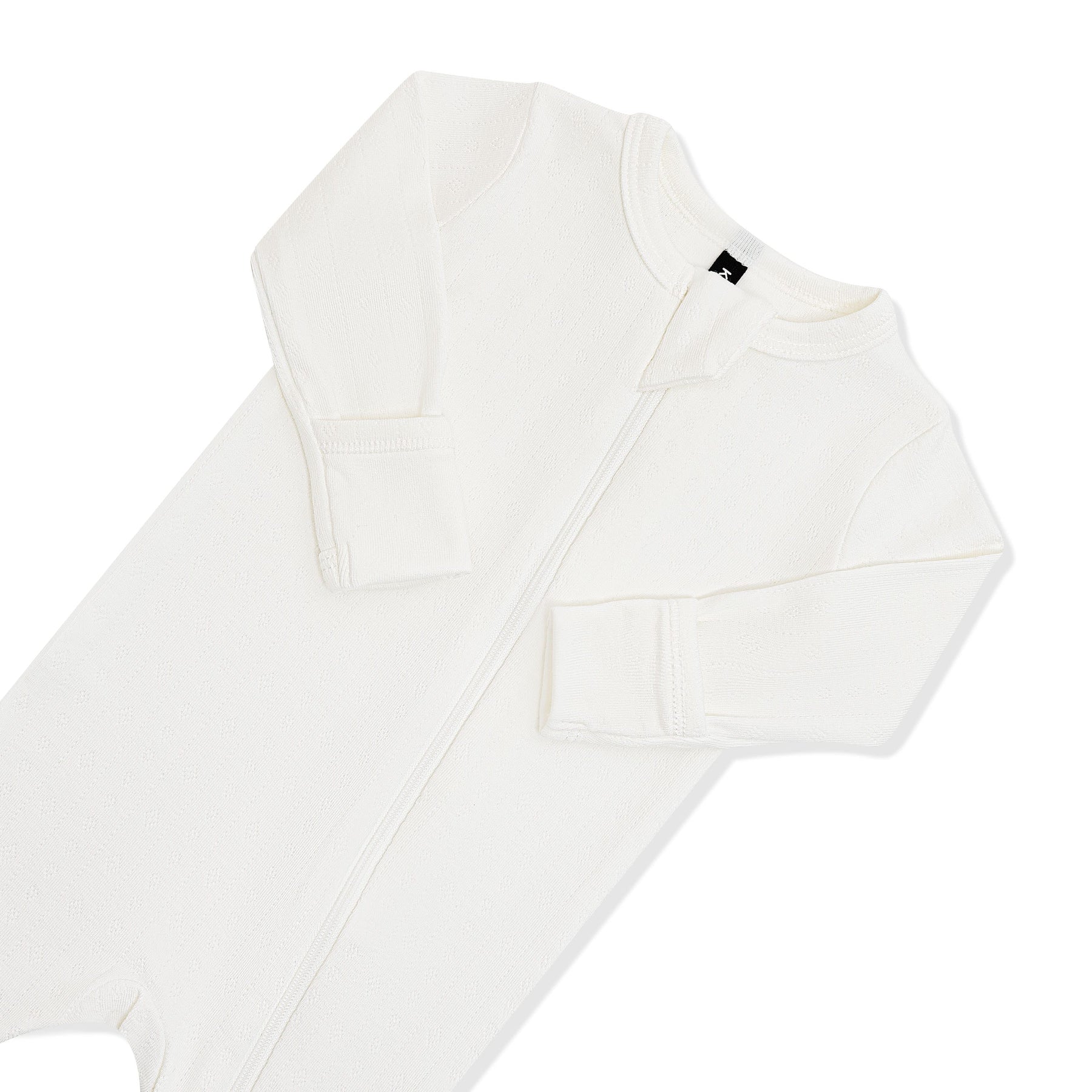 Close up of the zipper garage and fold over hand cuffs on the Pointelle Zippered Footie in Cloud