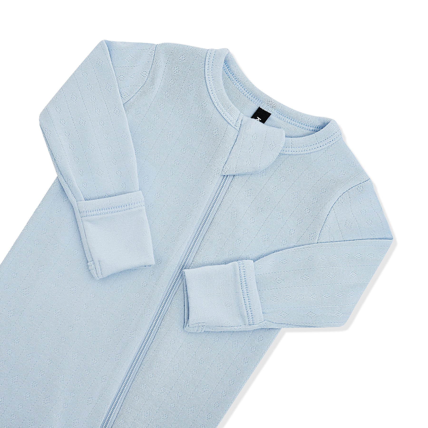 Close up of the zipper garage and fold over handcuffs on the Pointelle Zippered Footie in Breeze