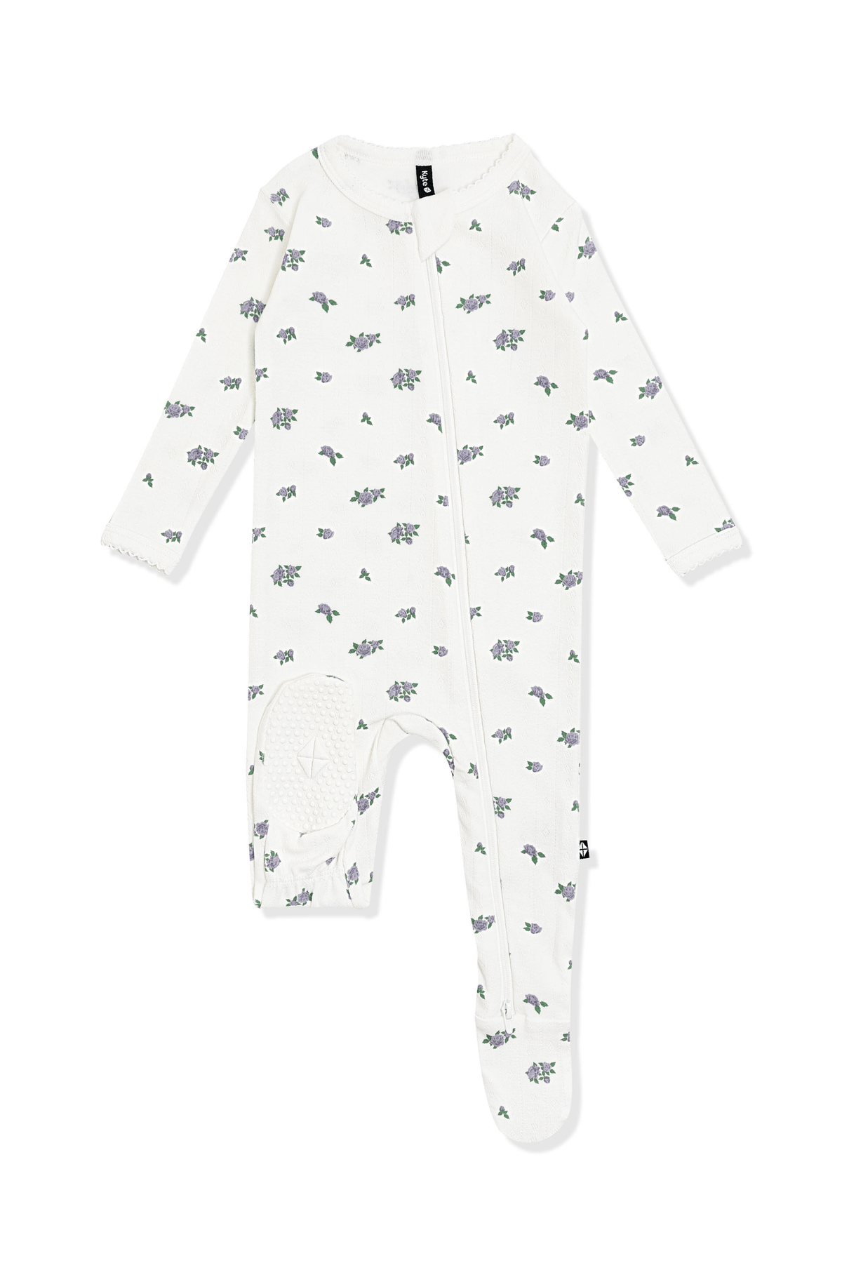 The bottom of the foot pad showing the kyte baby logo on the Pointelle Zippered Footie in Spray Rose with picot trim