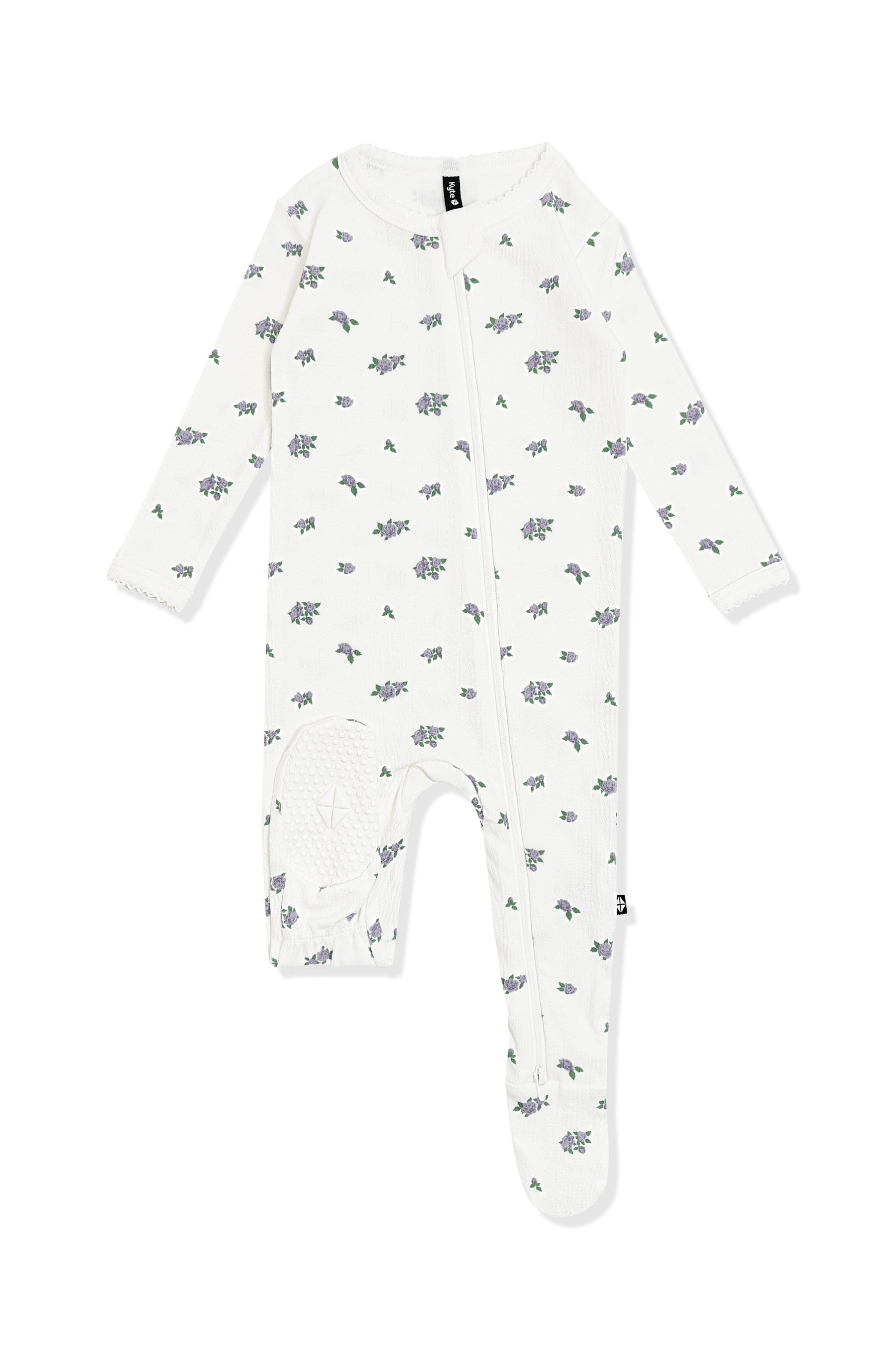 The bottom of the foot pad showing the kyte baby logo on the Pointelle Zippered Footie in Spray Rose with picot trim