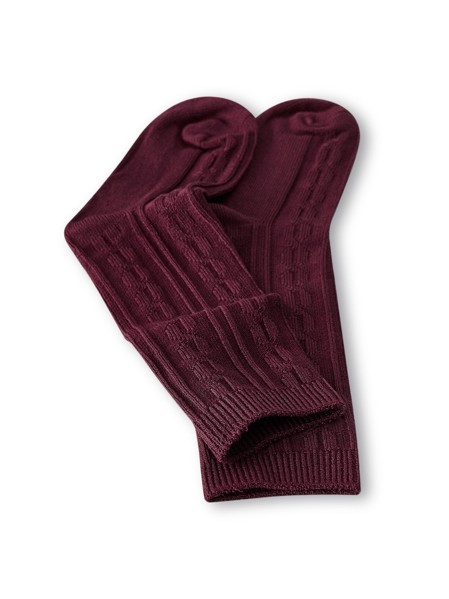 Knee high socks in burgundy laying flat on a white background.