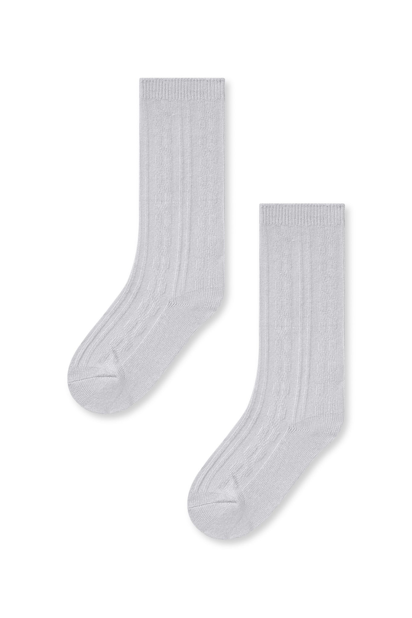 Knee high socks in storm laying flat on a white background.