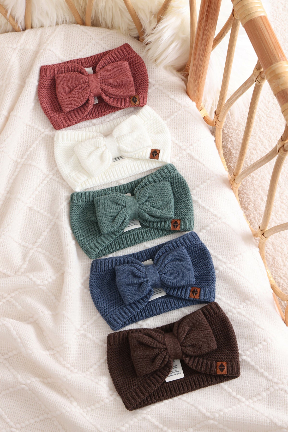Chunky Knit Bow Headband in Ember, Cloud, Pine, Oxford and Espresso lined in a crib