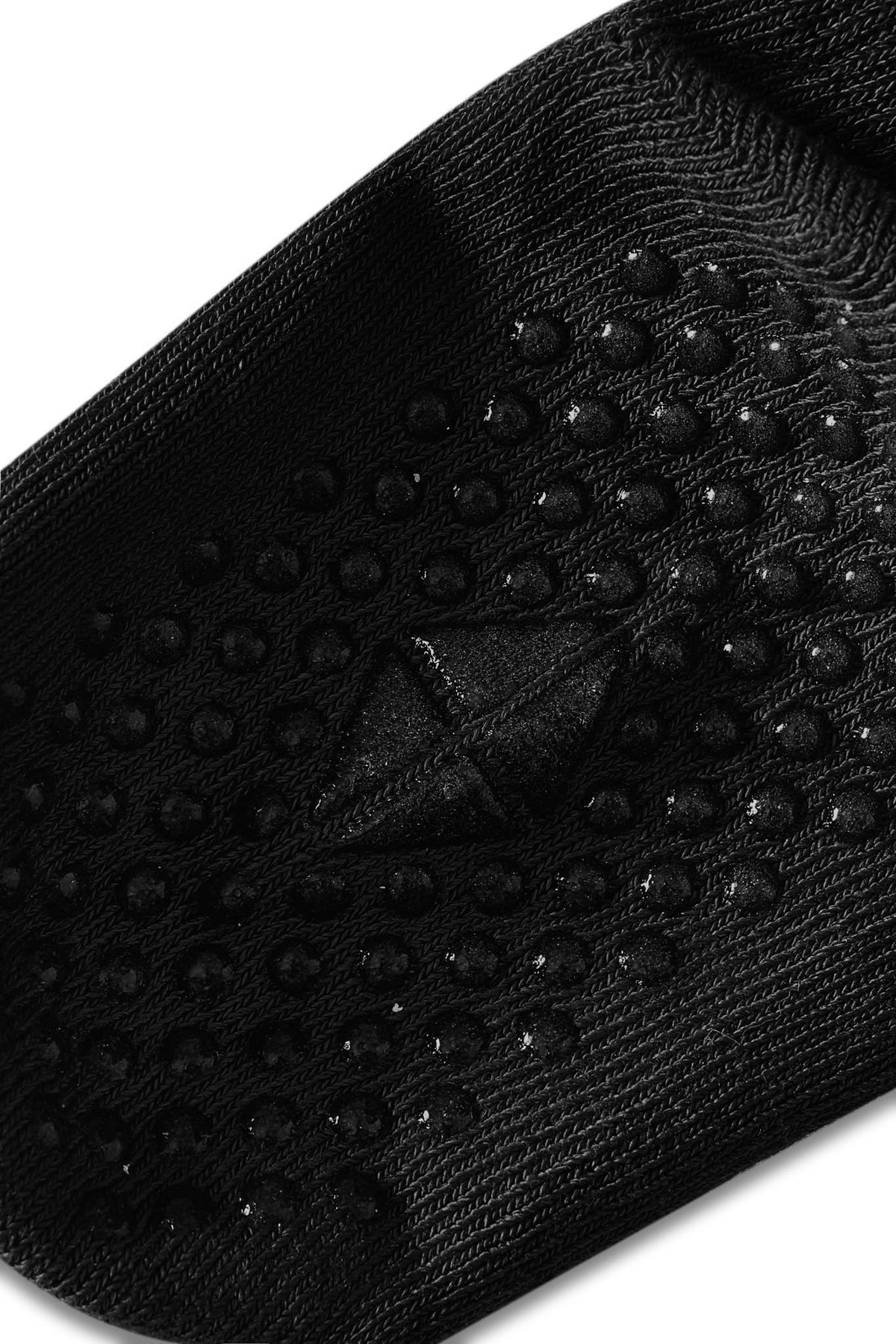 Angled bottom of a sock with grips.