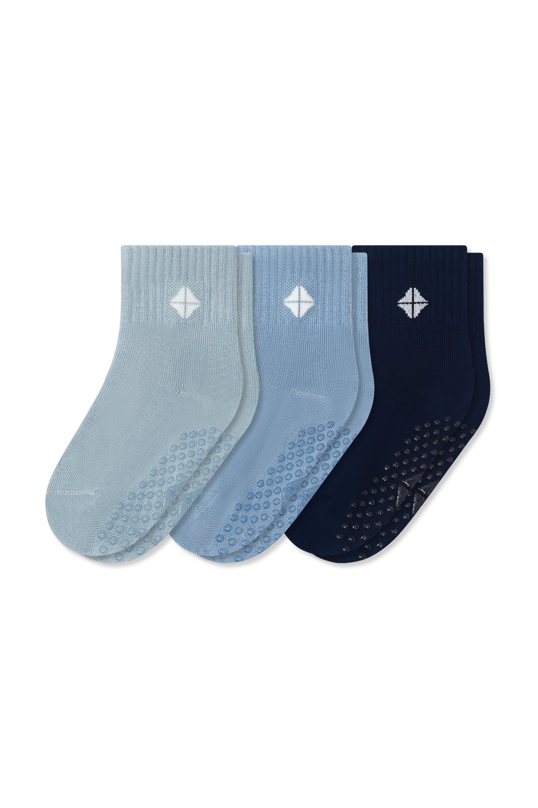 Three pairs of crew-cut grip socks in light blue, medium blue, and navy, arranged side-by-side on a plain white background.