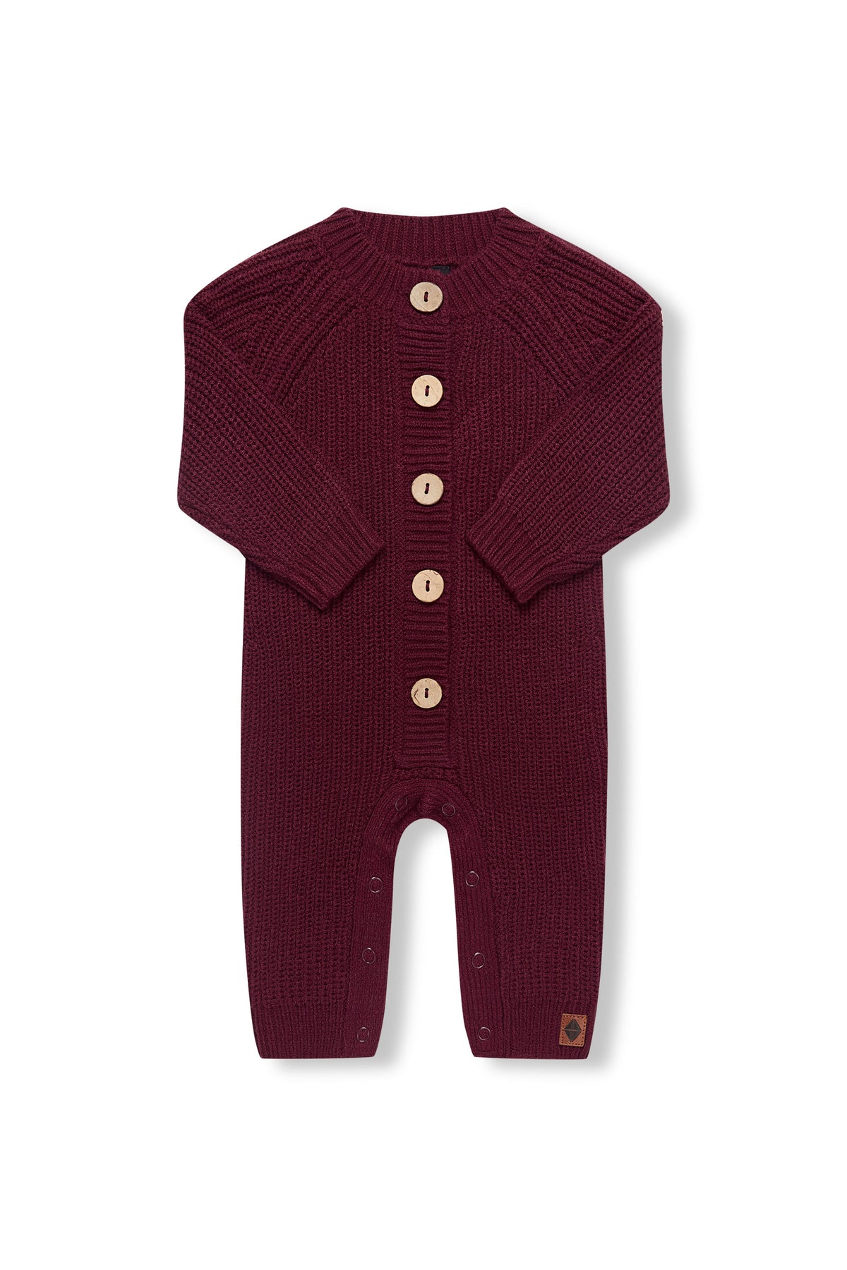 Chunky Knit Jumpsuit in burgundy with folded sleeves on a white background