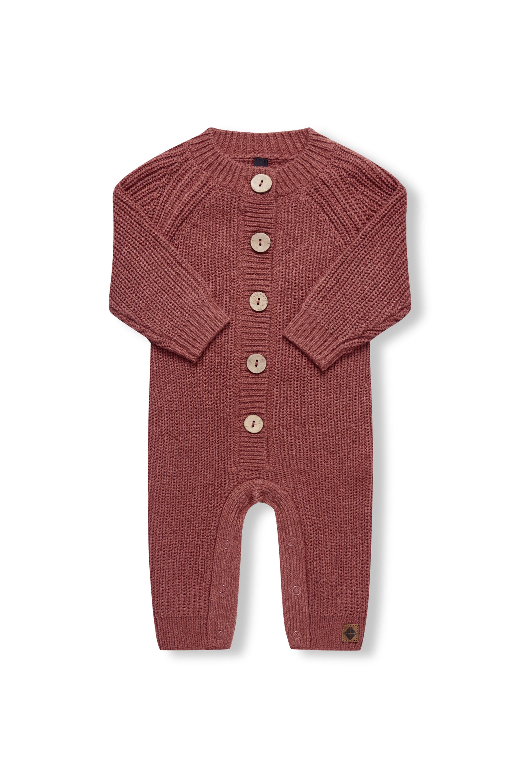 Chunky Knit Jumpsuit in ember with folded sleeves on a white background