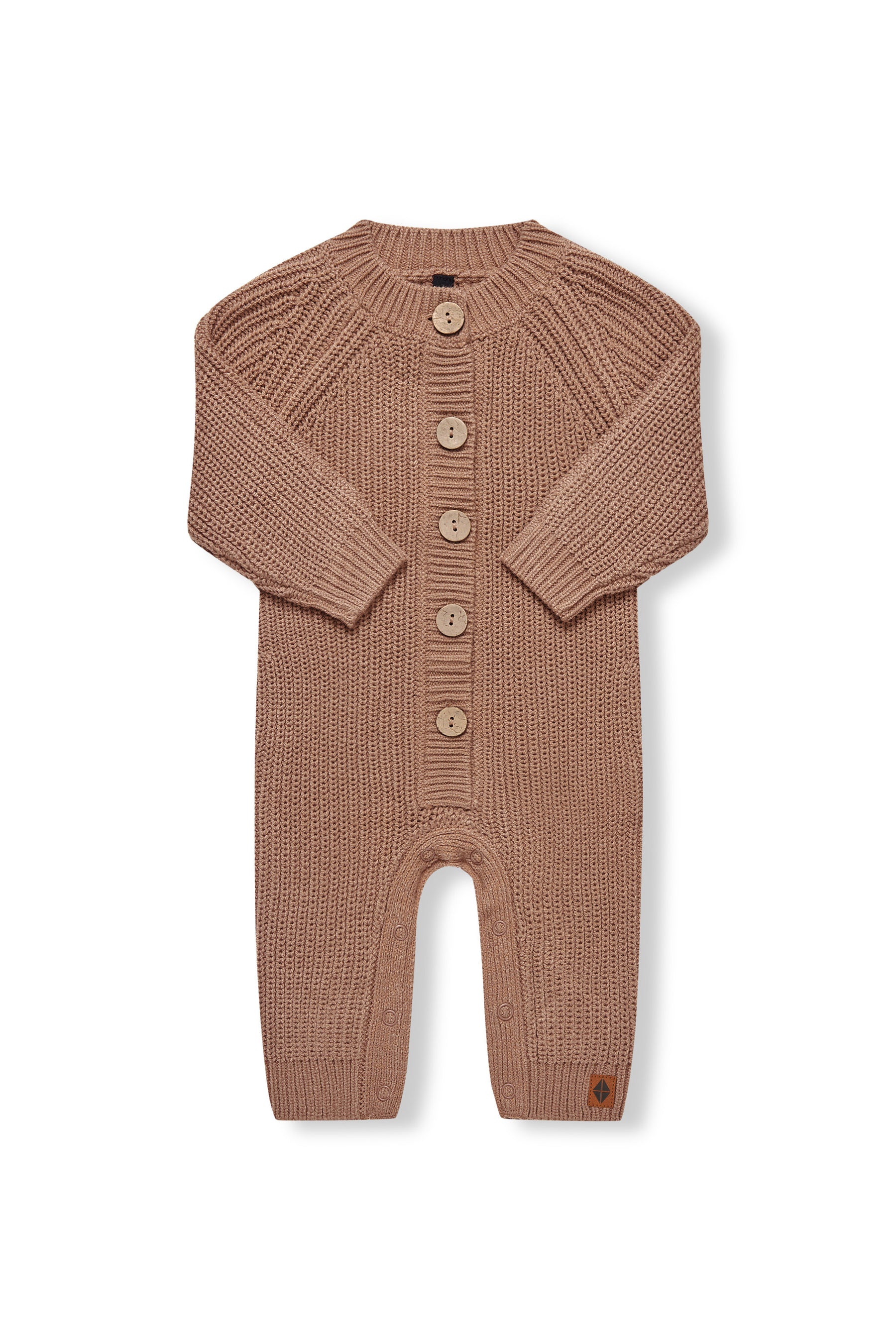 Chunky Knit Jumpsuit in latte with folded sleeves on a white background