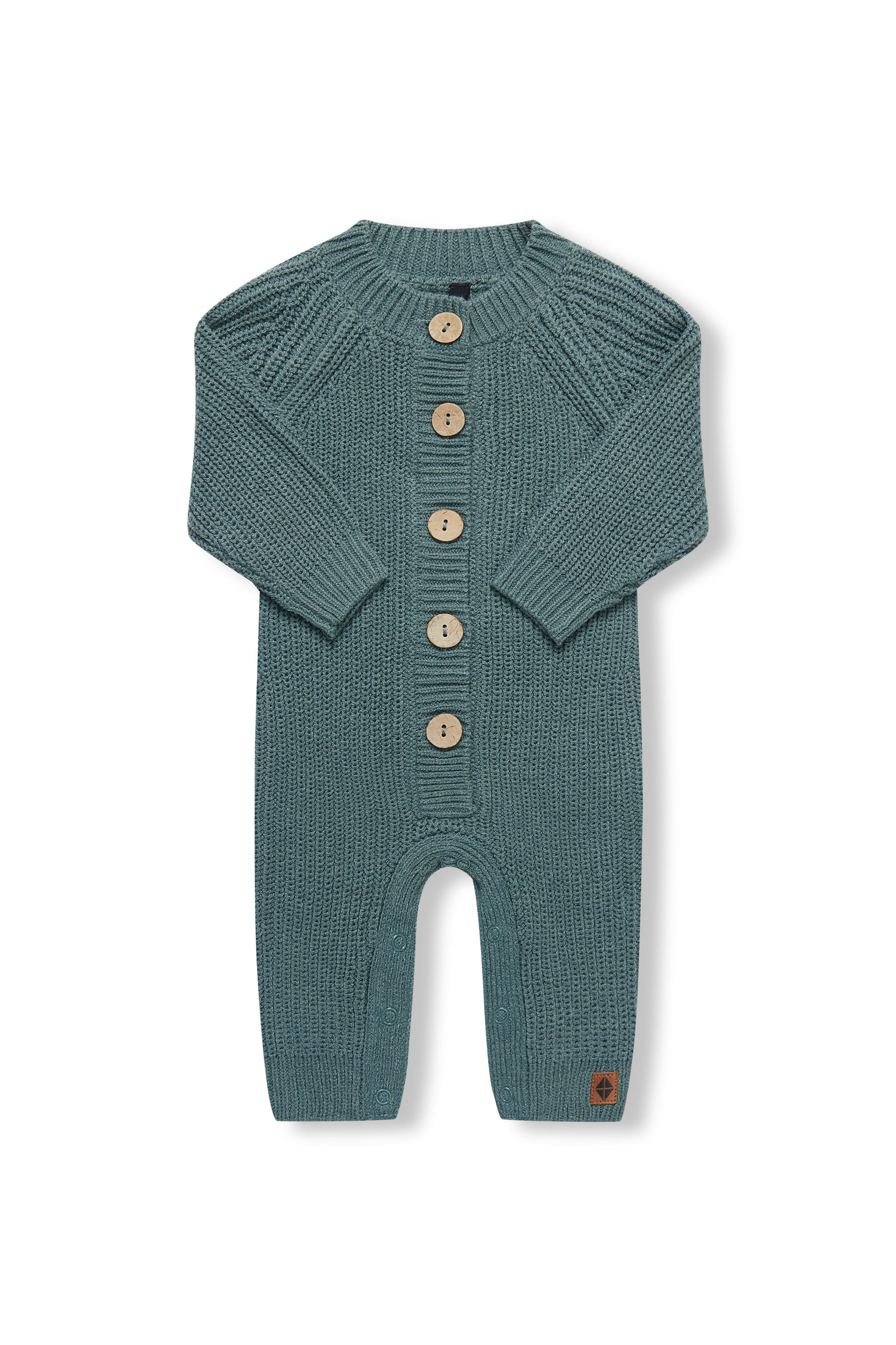 Chunky Knit Jumpsuit in Pine with folded sleeves on a white background