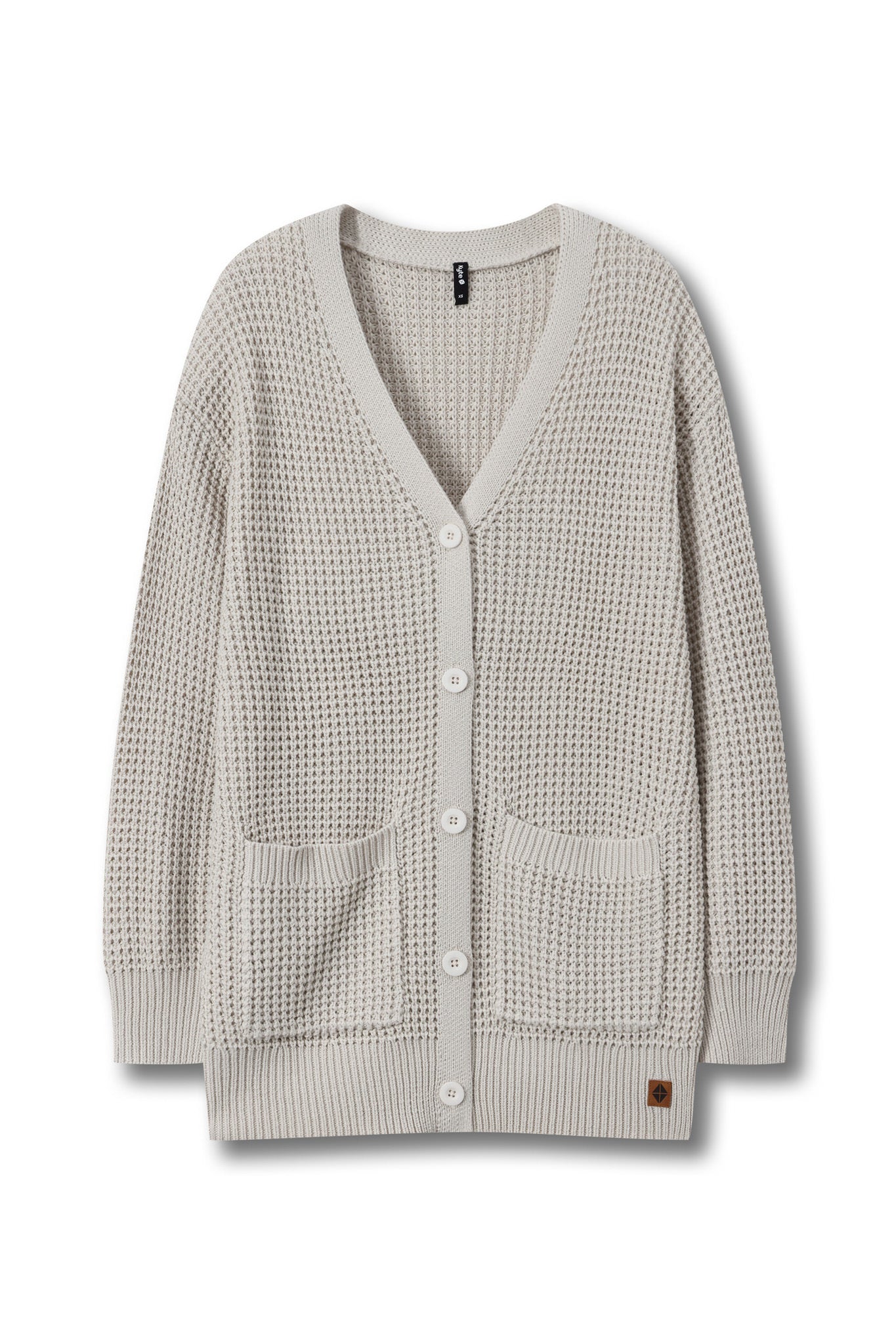A light beige waffle-knit cardigan sweater with a V-neck, white buttons, and two front patch pockets, shown against a plain white background.