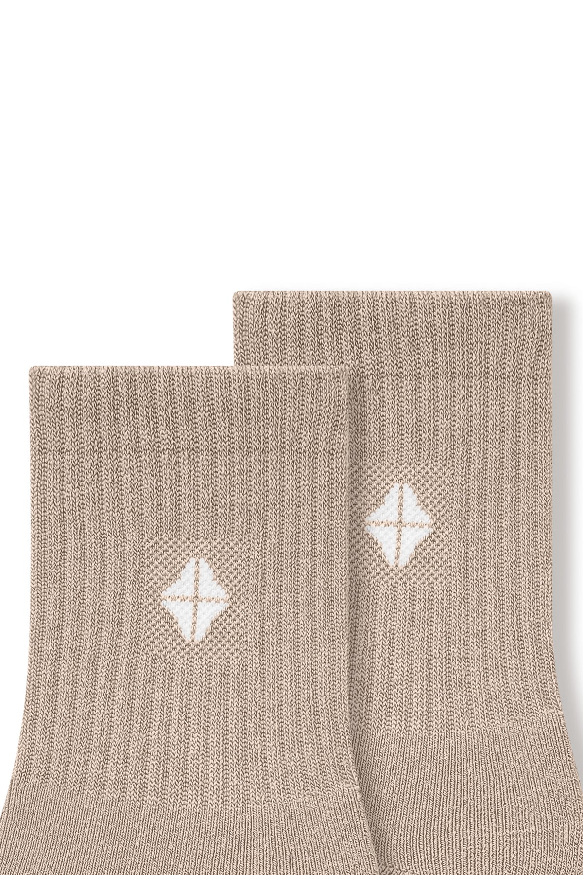 Top part of Adult Crew Socks in Bisque with Kyte Baby logo on a white background