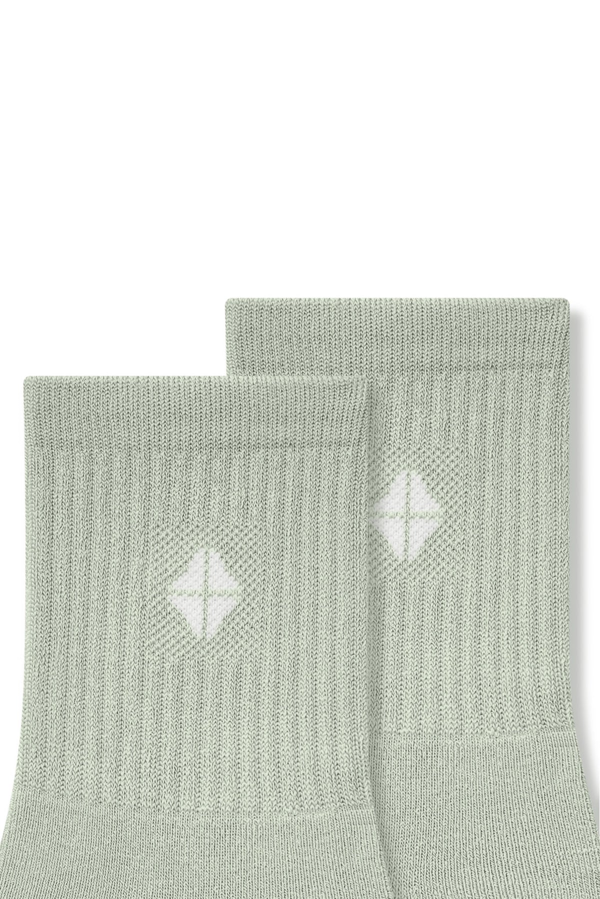 Top part of Adult Crew Socks in Thyme with Kyte Baby logo on a white background