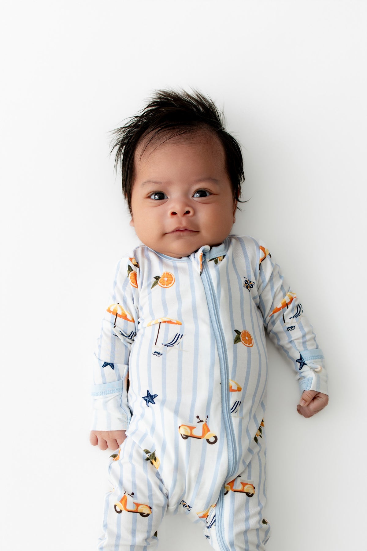 Close up of newborn wearing the Zippered Romper in Amalfi Coast