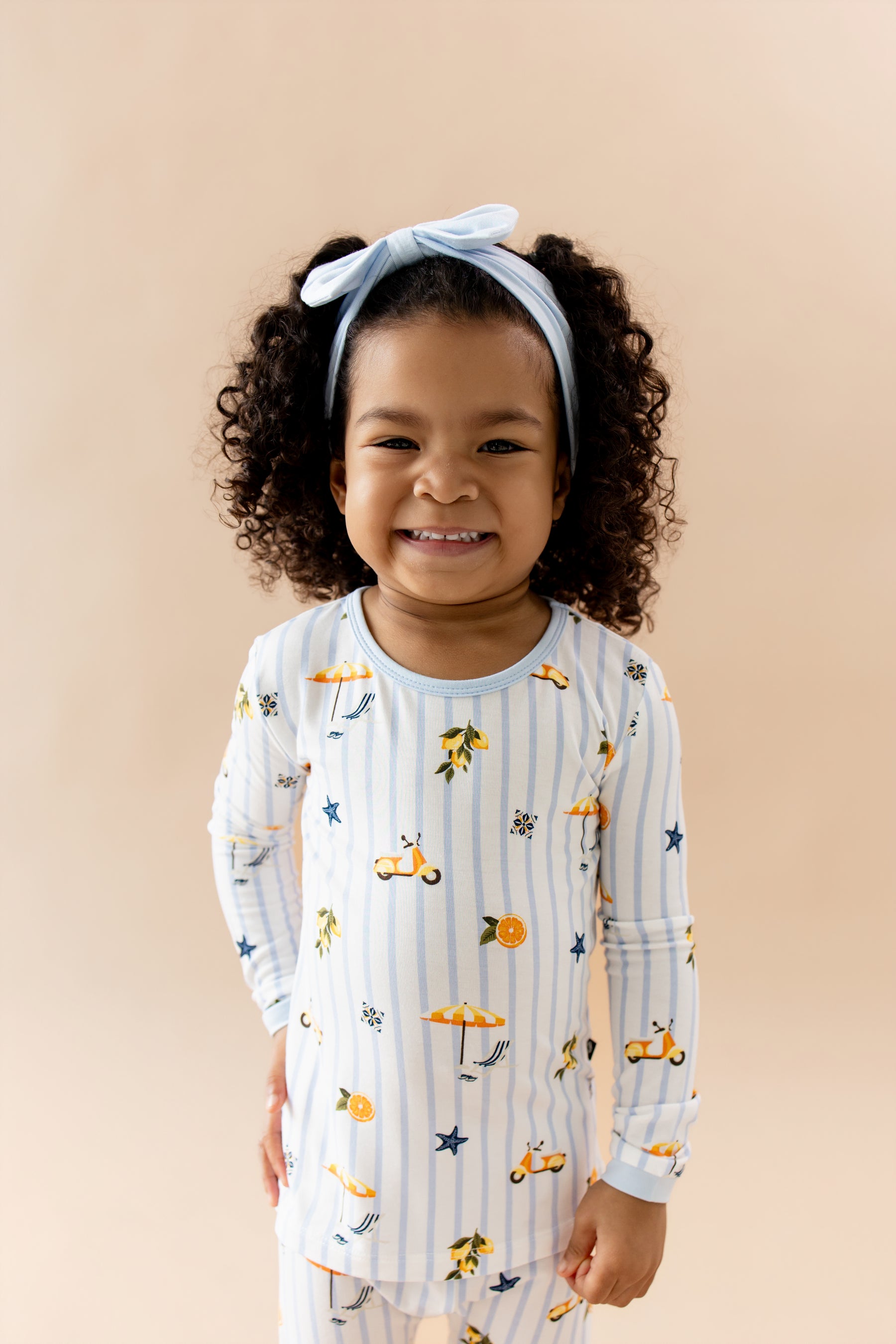 Close up of a young smiling girl wearing the Long Sleeve Pajamas in Amalfi Coast