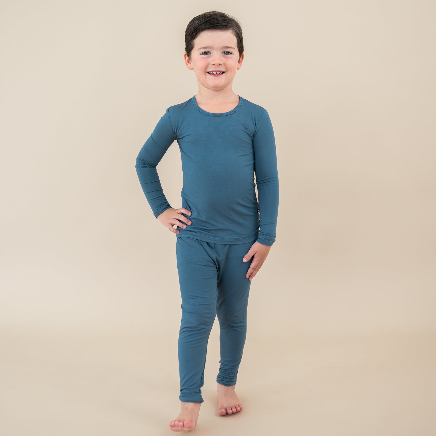 Kid standing with hand on his hip wearing the Long Sleeve Pajamas in Atlantic