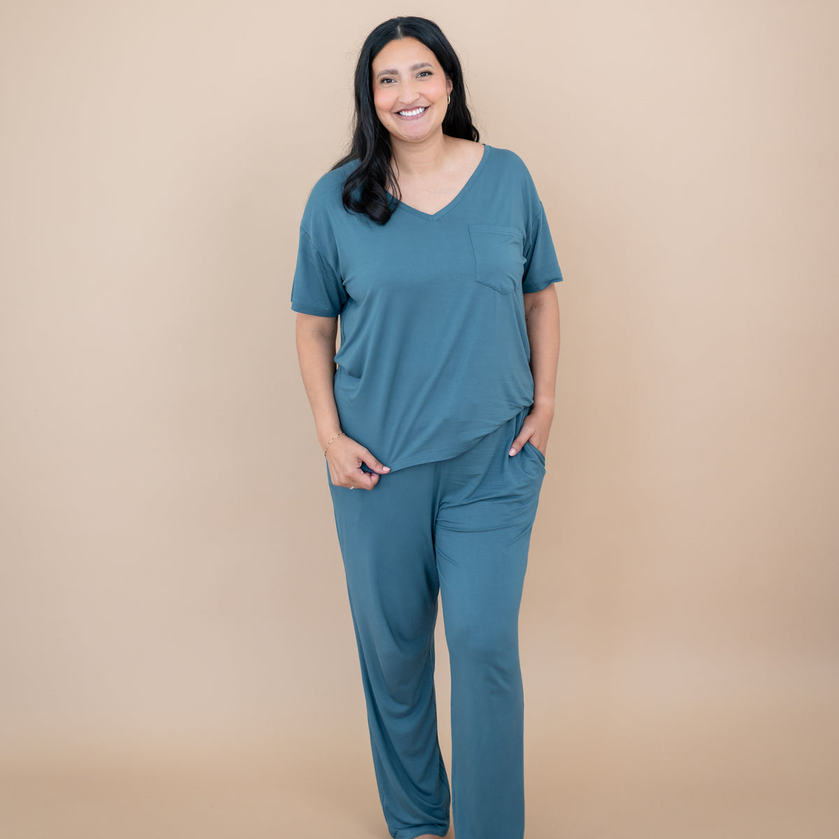 Smiling model wearing the Women's Lounge Pants in Atlantic with matching women's v-neck