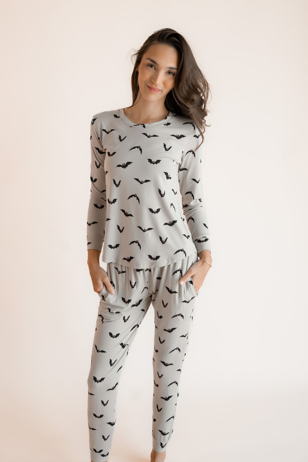 Modal posing in Women's Jogger Pajama Set in Bats print on a white background