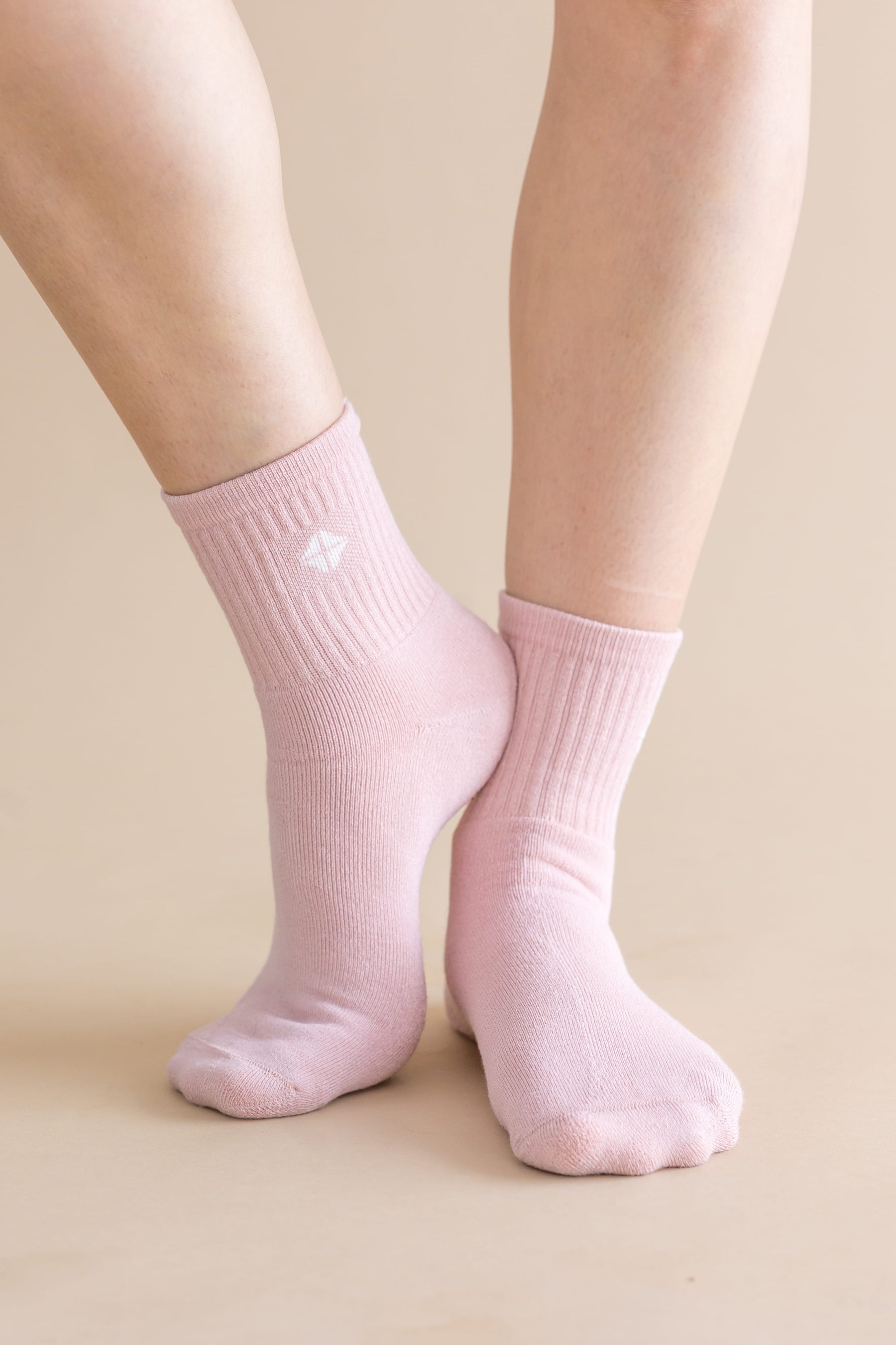 Adult Crew Socks in Blush shown on the feet of a model