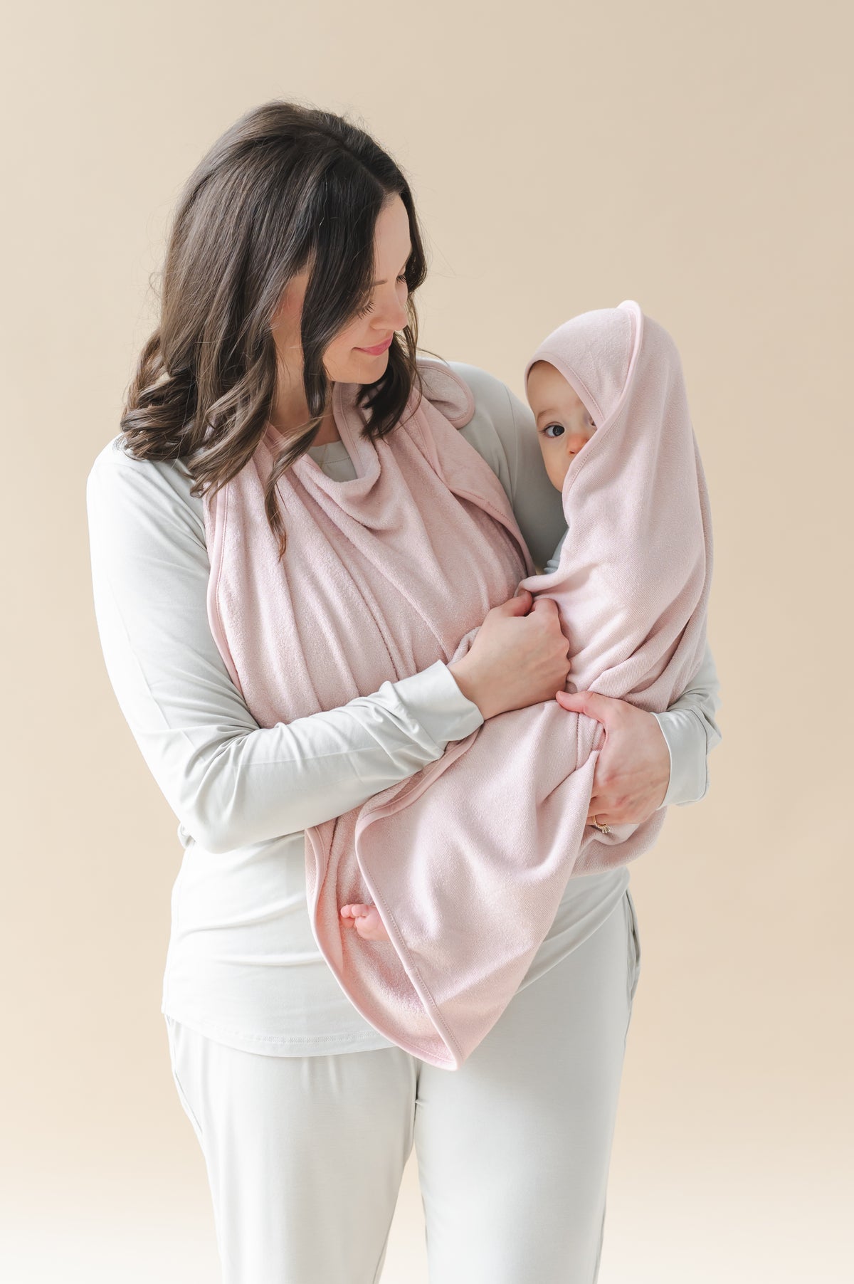 Mother holding her infant wrapped in the Terry Apron Towel in Blush