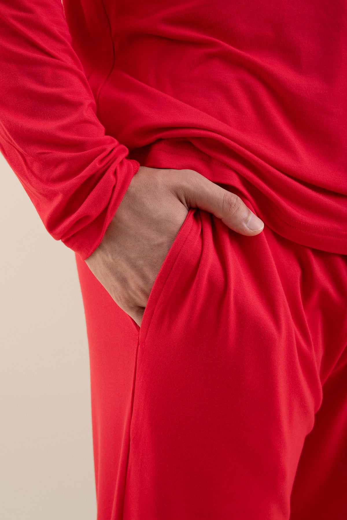 The pocket of the pants shown of the Men's Jogger Set in Cardinal on a male model
