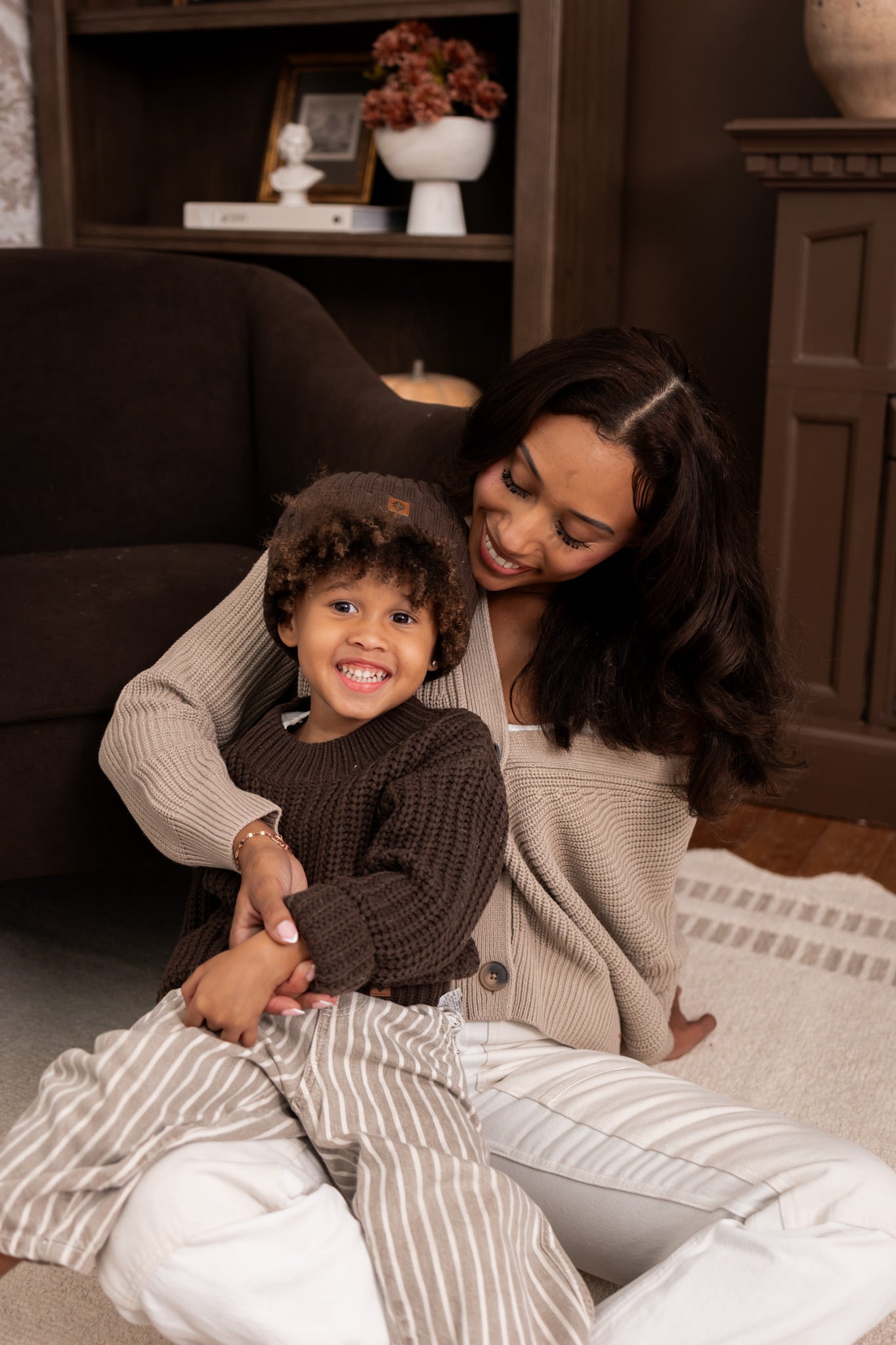Modal wearing Chunky Knit Women's Cropped Cardigan in Almond with child wearing chunky knit ribbed beanie and Chunky knit sweater in espresso