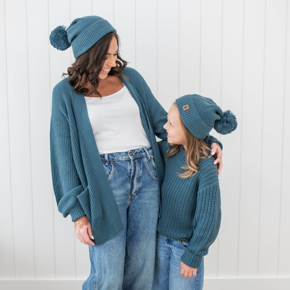 Mom and daughter matching in Chunky Knit Pom Beanies in Atlantic 
