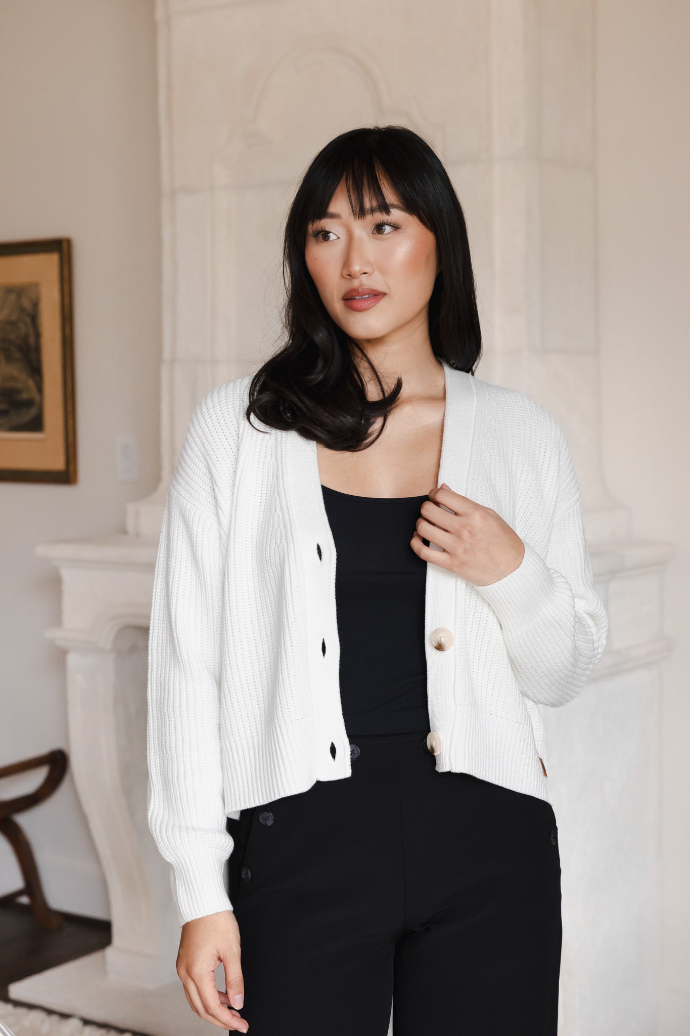 Modal wearing Chunky Knit Women's Cropped Cardigan in Cloud over a black outfit