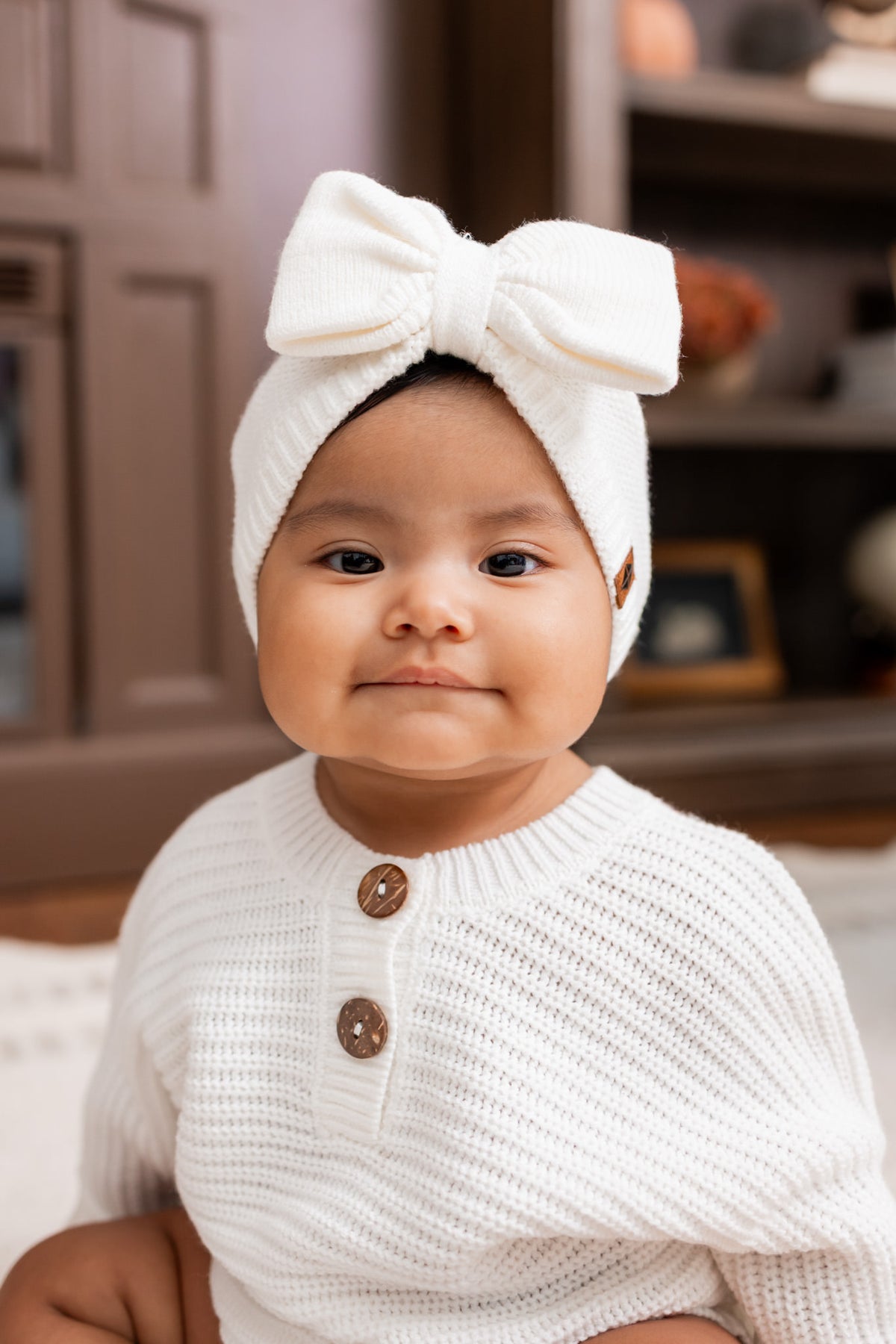Baby wearing Chunky Knit Romper and Chunky knit bow headband in cloud