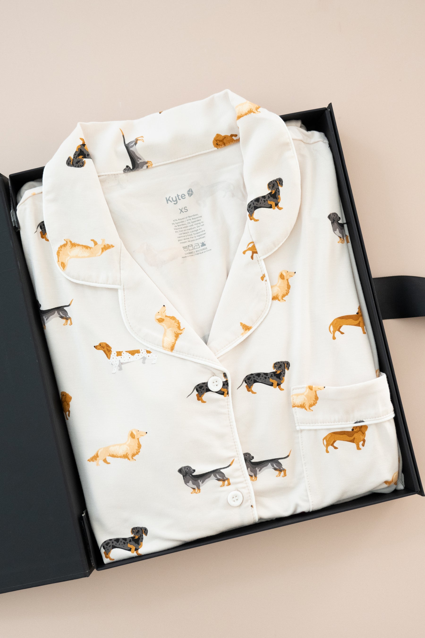 Long-Sleeved Women's Pajama Set in Dachshund print packed in a box on a beige background