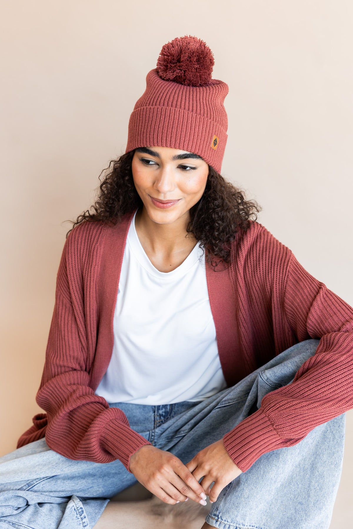 Modal wearing Chunky Knit Adult Pom in Ember over Chunky knit cardigan in ember