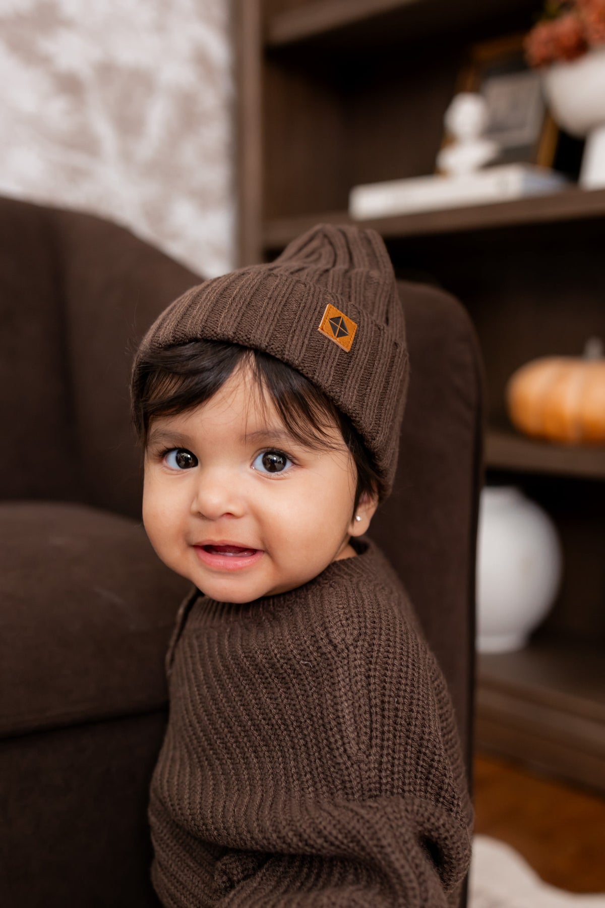 Baby wearing wearing Chunky knit ribbed beanie and Chunky knit romper in Espresso 