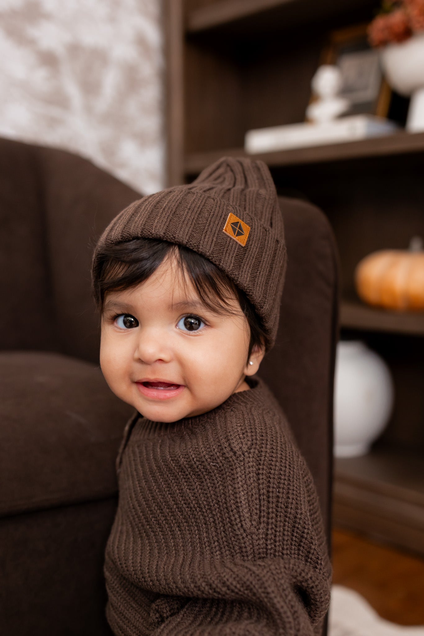 Baby wearing wearing Chunky knit ribbed beanie and Chunky knit romper in Espresso 