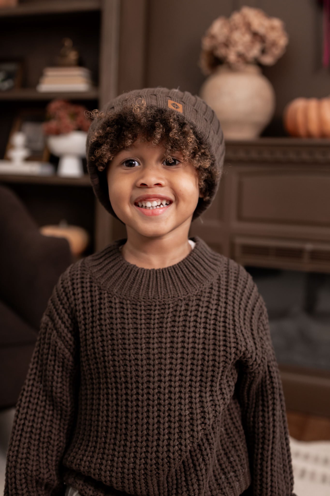 Boy smiling in Chunky Knit Sweater and chunky knit ribbed beanie in espresso 