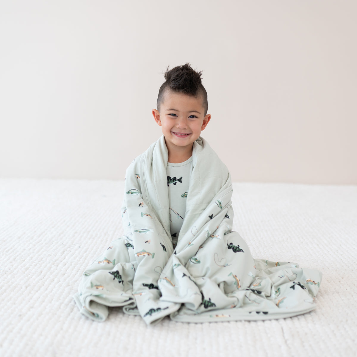 Sitting Toddler in Fishing Pajamas wrapped in Youth Blanket in Fishing 2.5