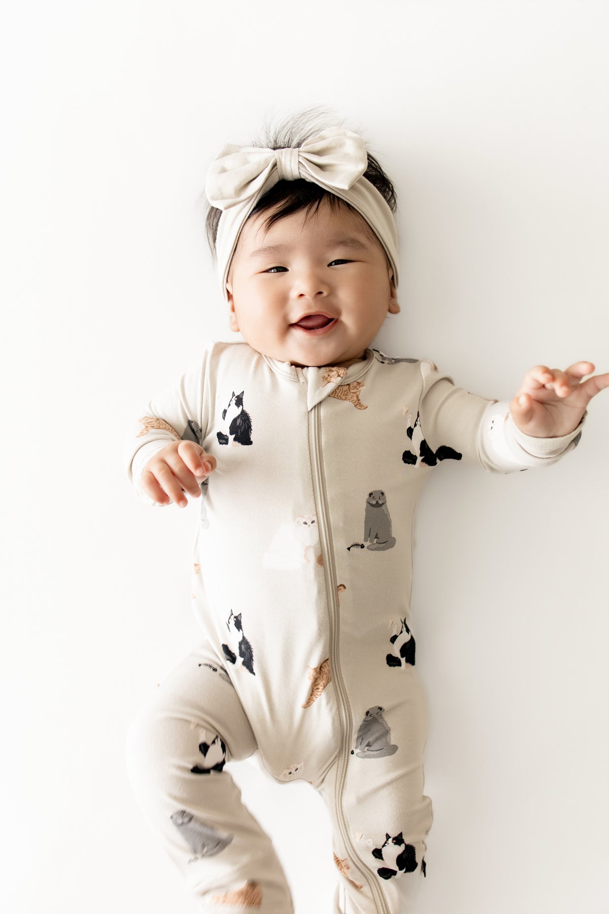Close up of infant wearing the Zippered Romper in Fluffy Cat