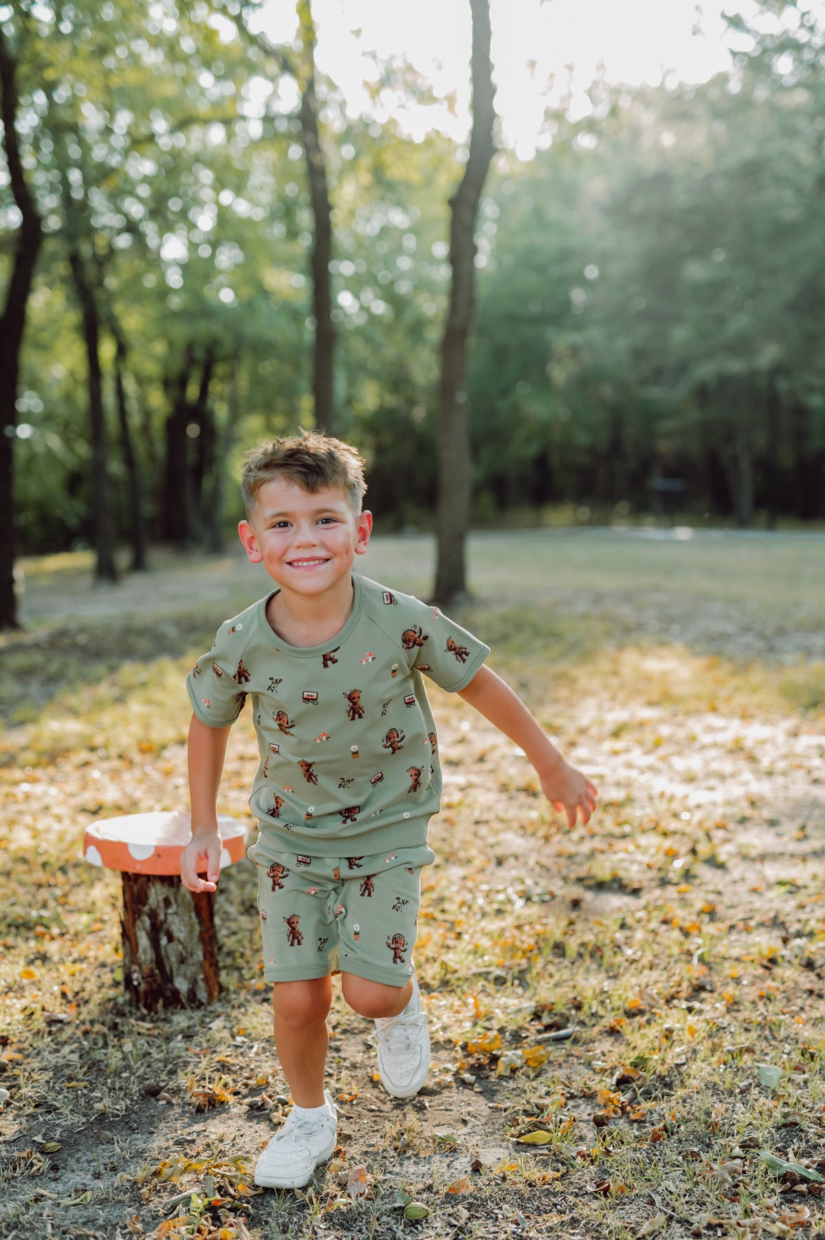 Boy outside running in groot short sleeve jogger set.