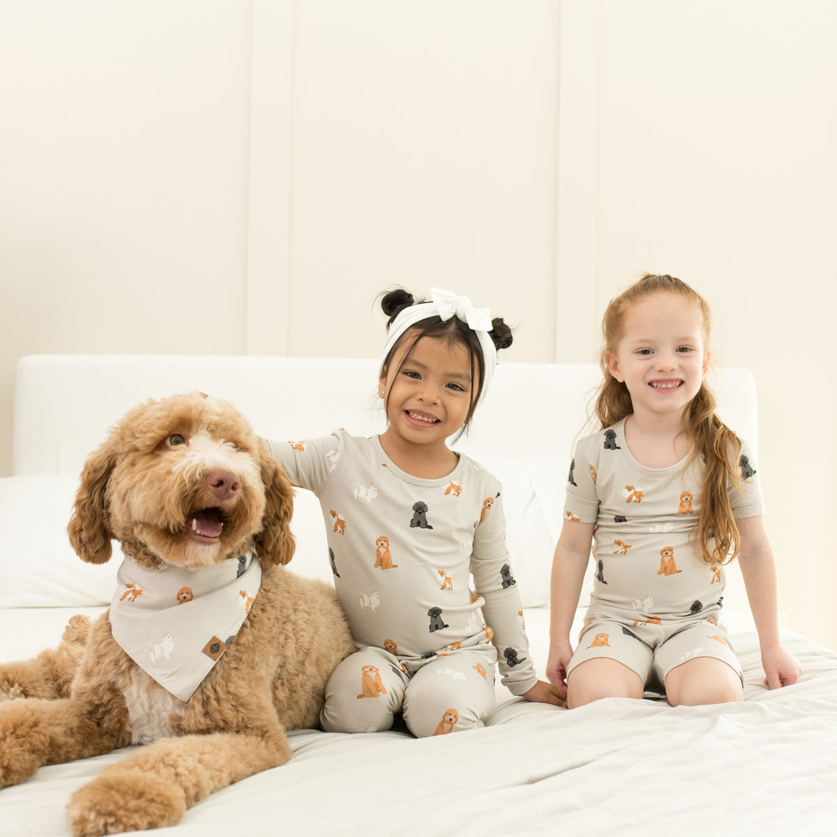 2 kids wearing Short Sleeve and Long Sleeve Pajamas in Fluffy Dog next to dog 