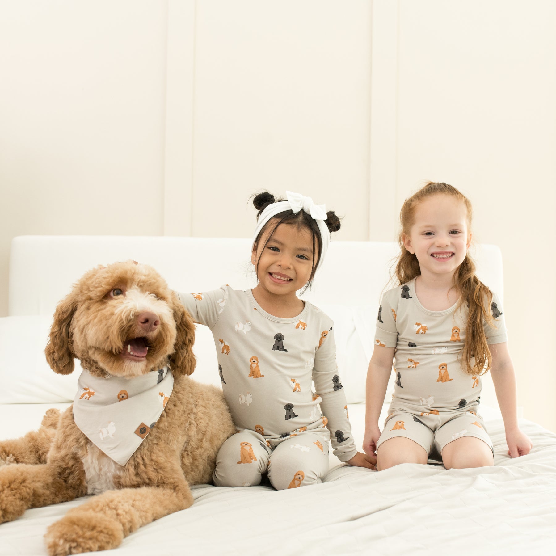 2 kids wearing Short Sleeve and Long Sleeve Pajamas in Fluffy Dog next to dog 