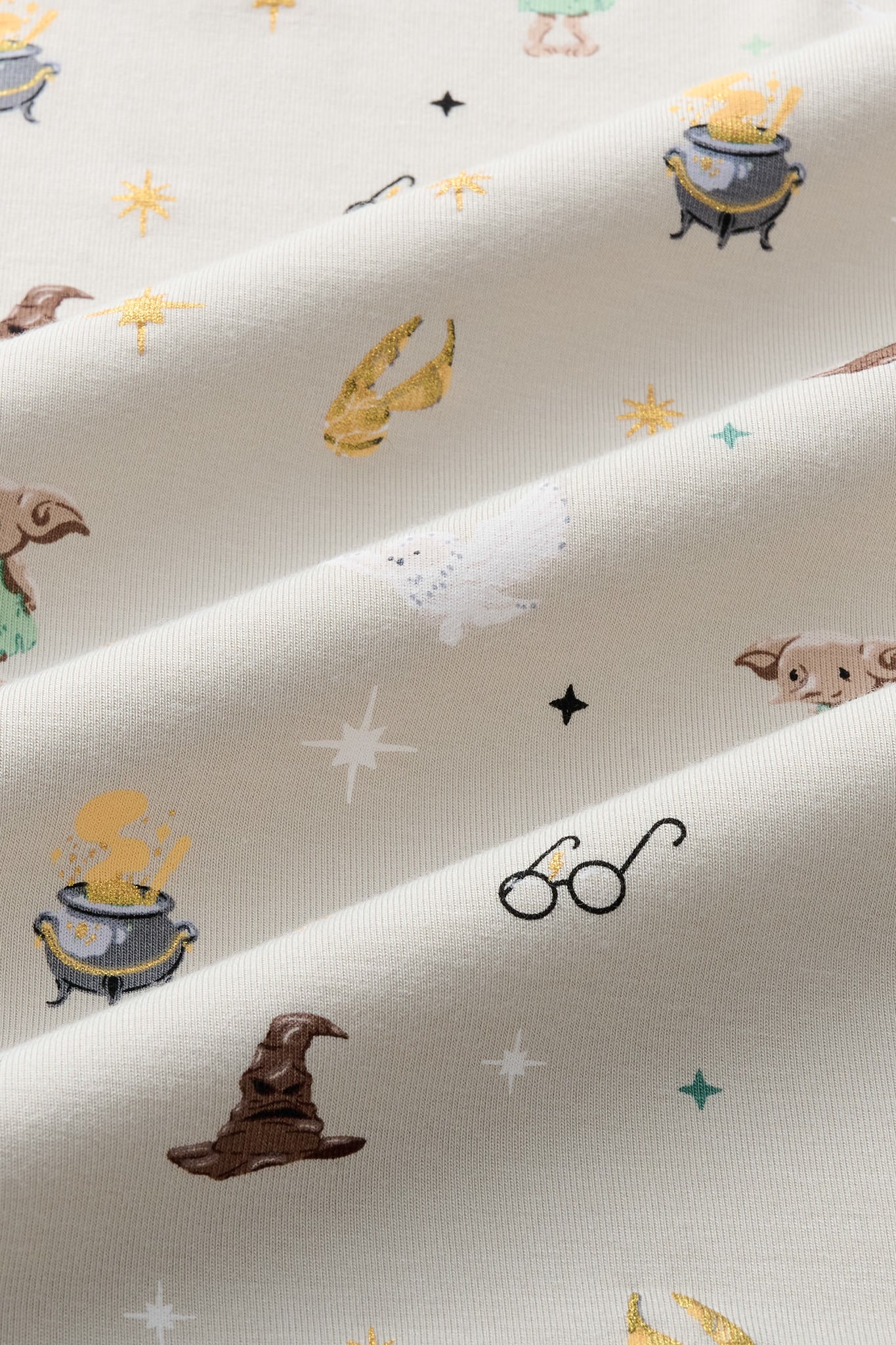 Close up of Beige fabric with Starry Icon Harry Potter patten print