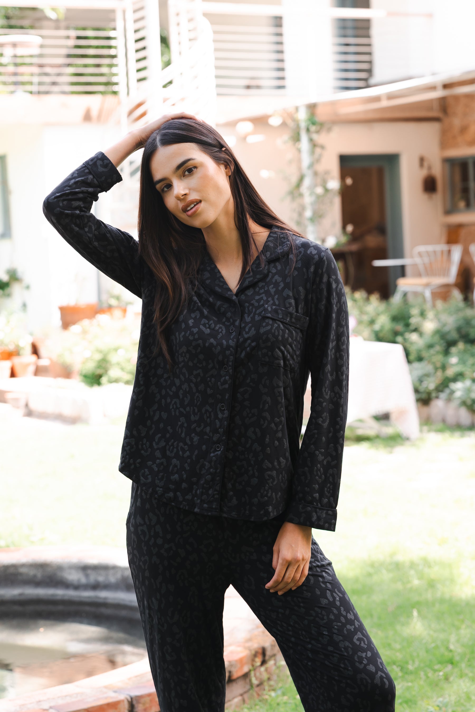 Female posing wearing the Long-Sleeved Women's Pajama Set in Midnight Leopard