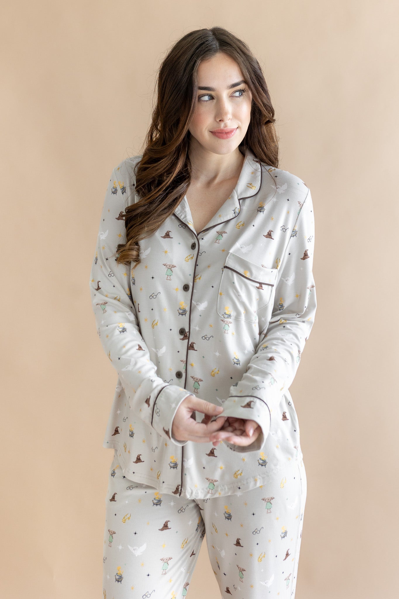Model wearing a cream Long-Sleeved Women's Pajama Set with Harry Potter prints on a beige background