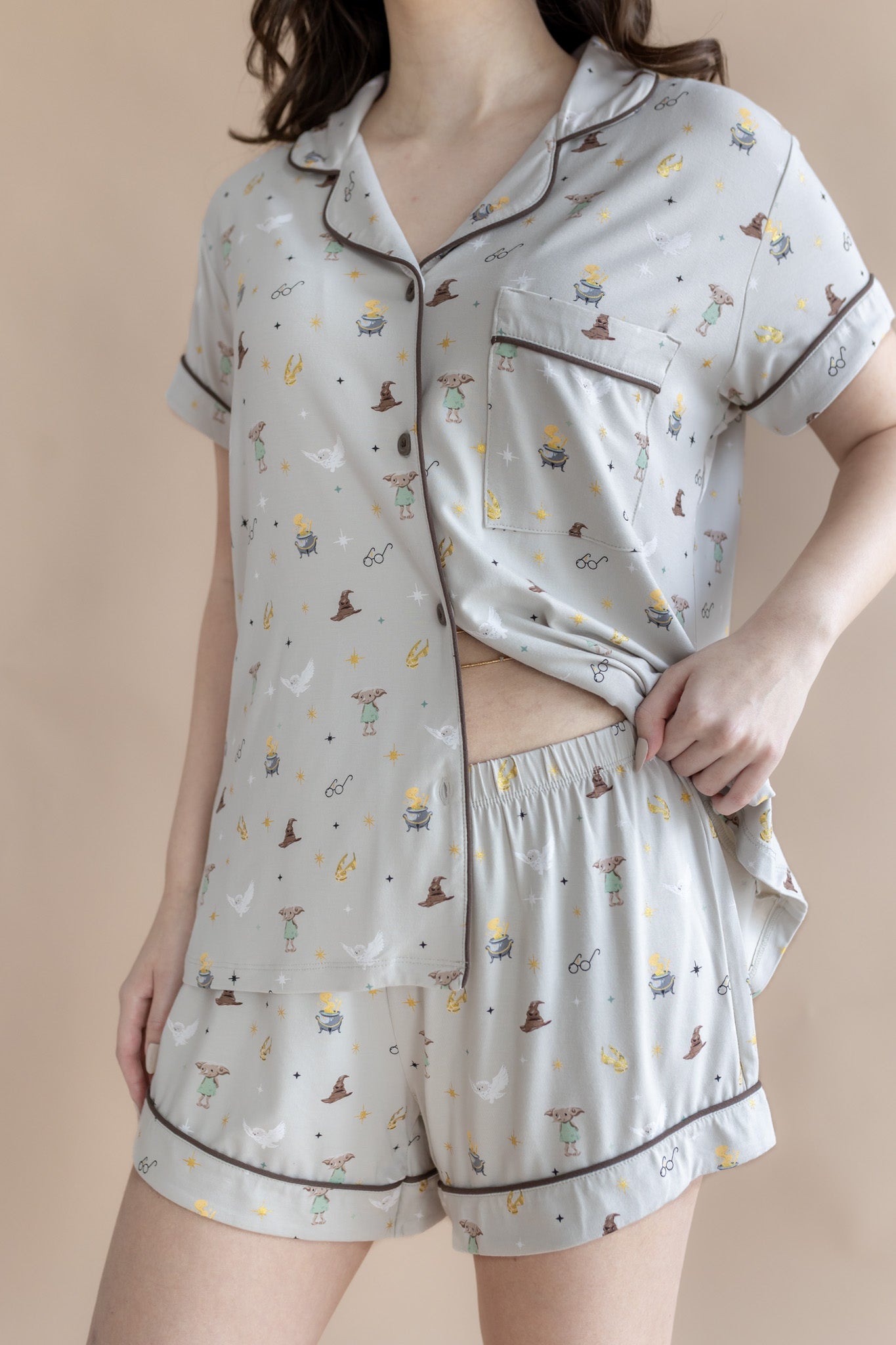 Model wearing Women's Short Sleeve Pajama Set with Harry Potter prints on a beige background