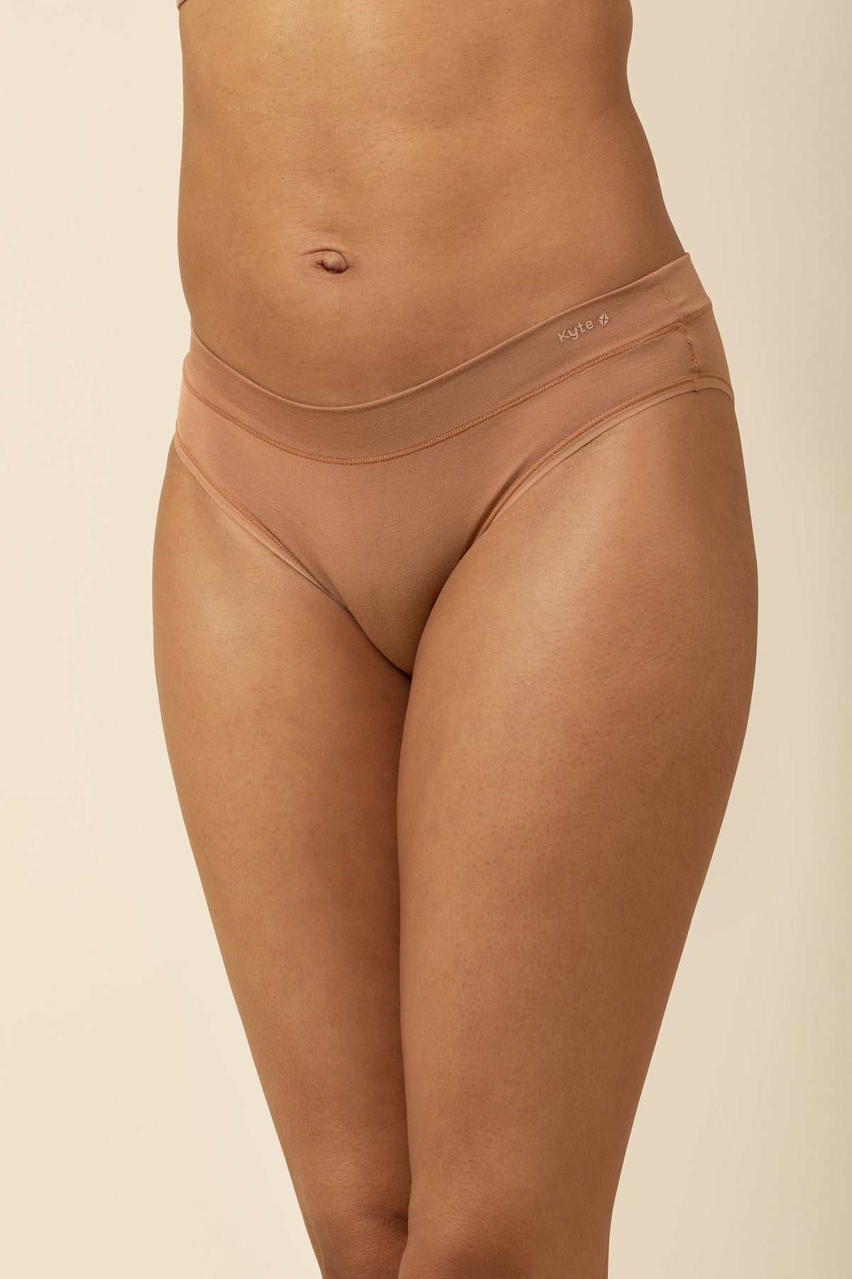 Brown underwear worn by a person on a beige background