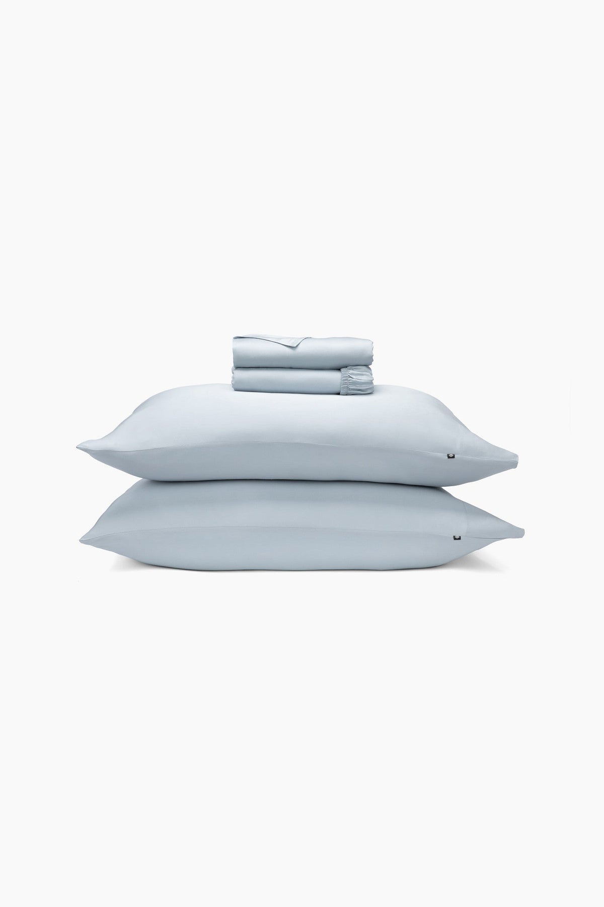 Light blue bedding set including 2 pillows, fitted sheet and fitted sheet folded. 