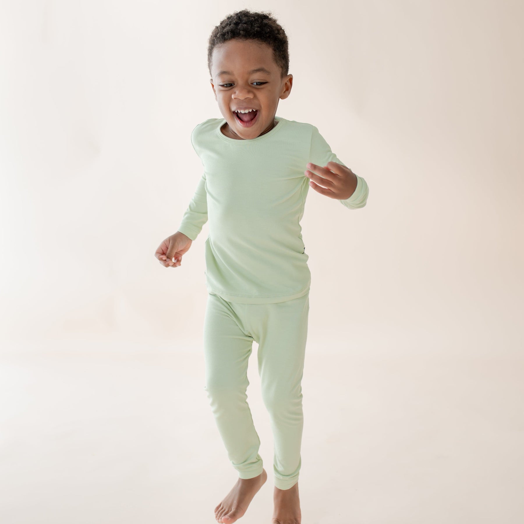 Toddler wearing light green long sleeve and pant pajama set 