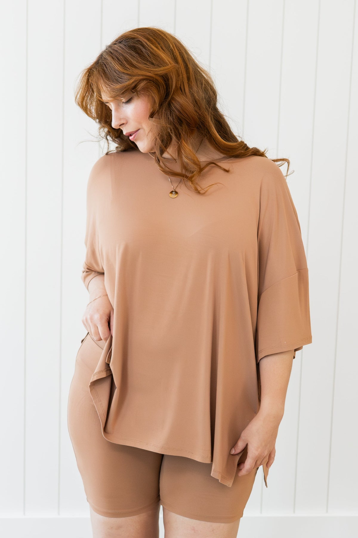 Female looking off to the side wearing the Women’s Biker Short Set in Latte