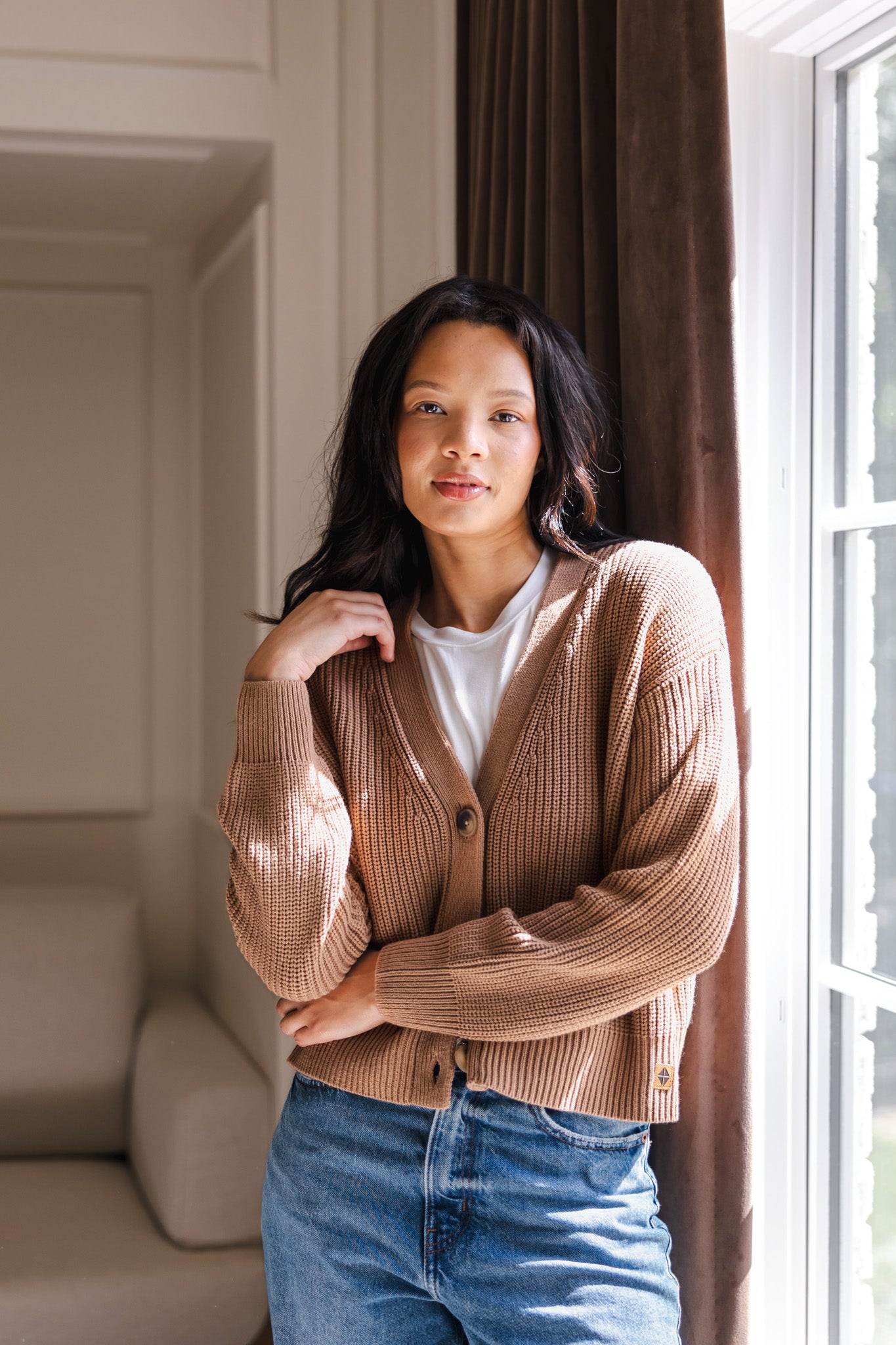 Modal wearing Chunky Knit Women's Cropped Cardigan in Latte over blue jeans