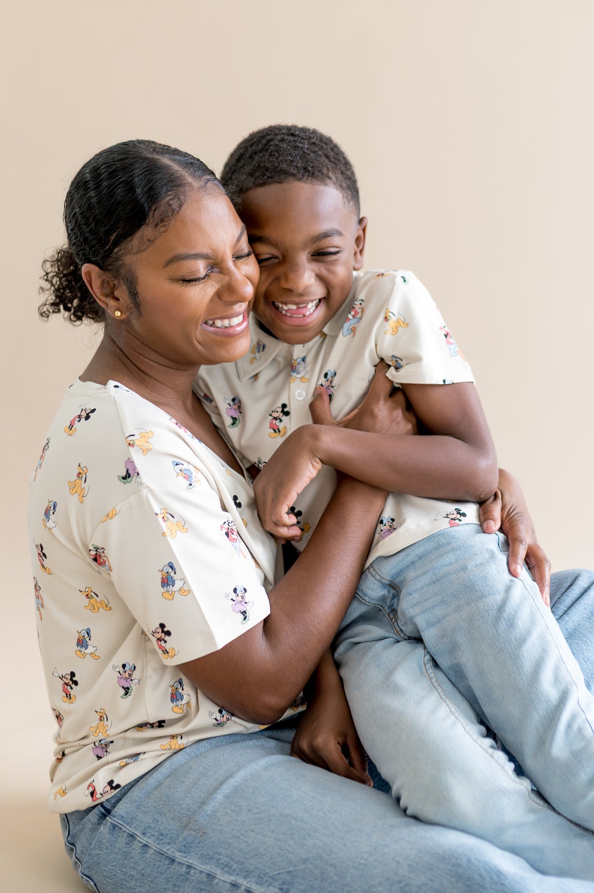 Mom and child wearing matching mickey mouse patterned shirts