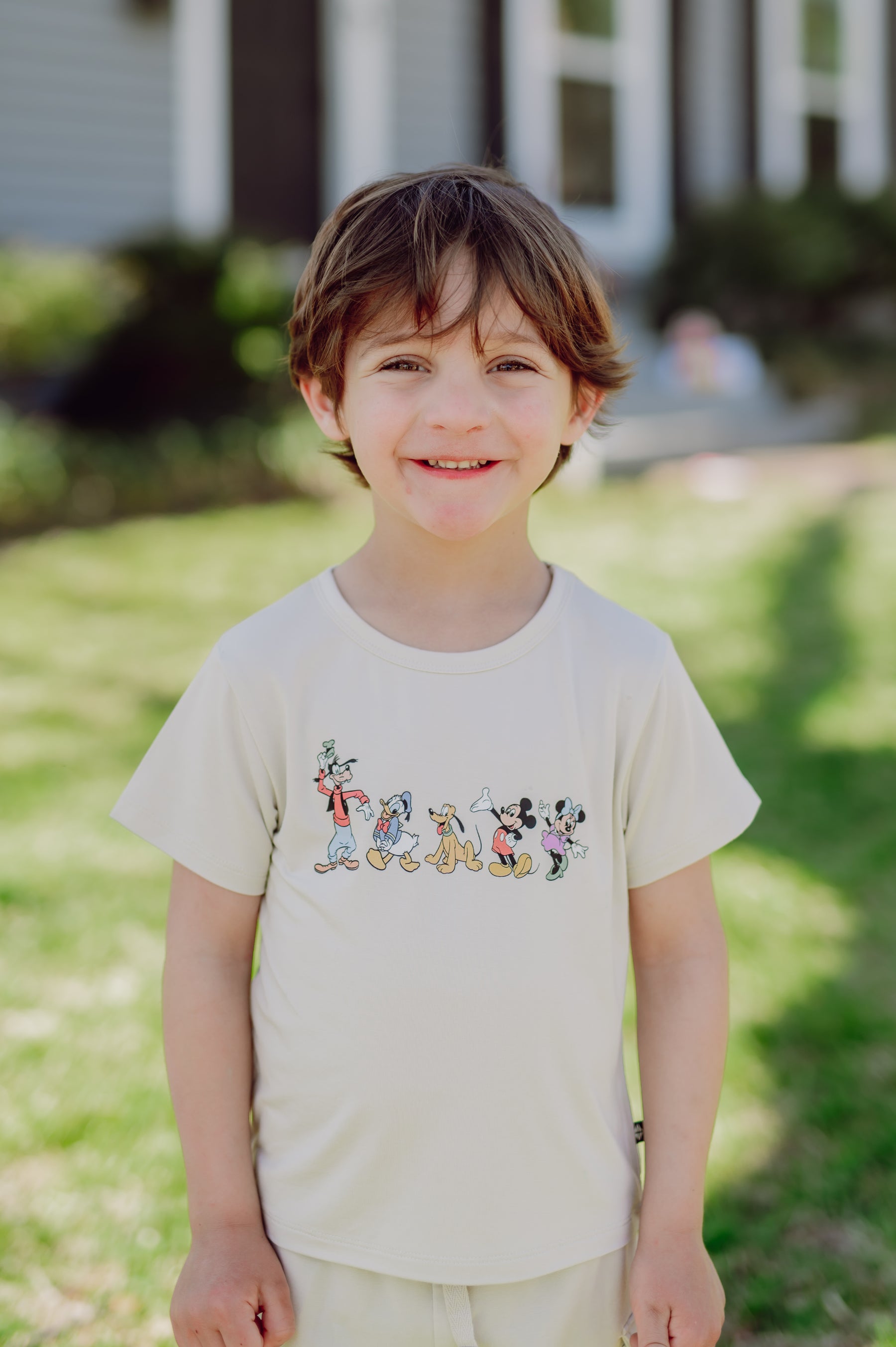 Toddler wearing a mickey and friends graphic tee outdoors